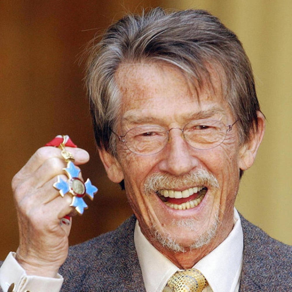 John Hurt Holding Flower Trinket Background