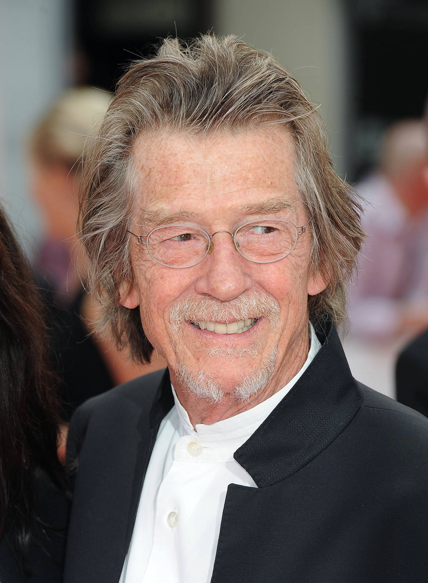 John Hurt In Suit And Glasses