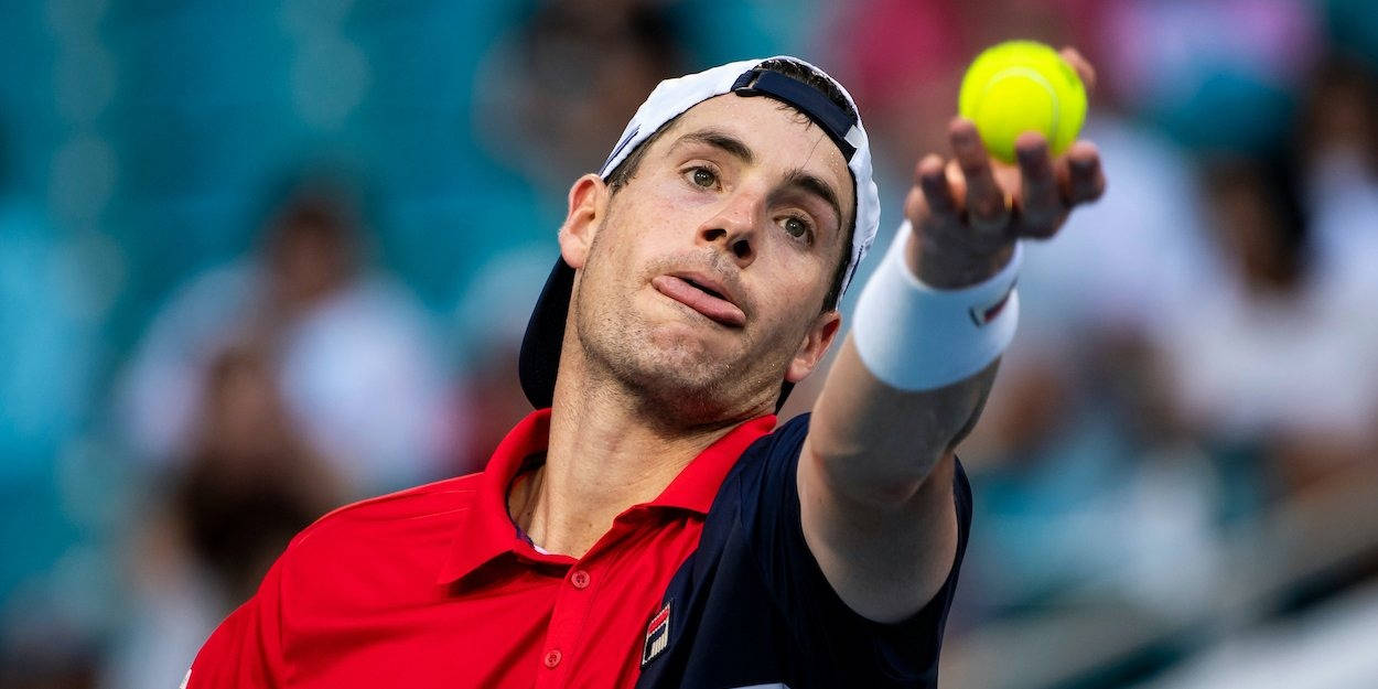 John Isner Holding A Tennis Ball Background