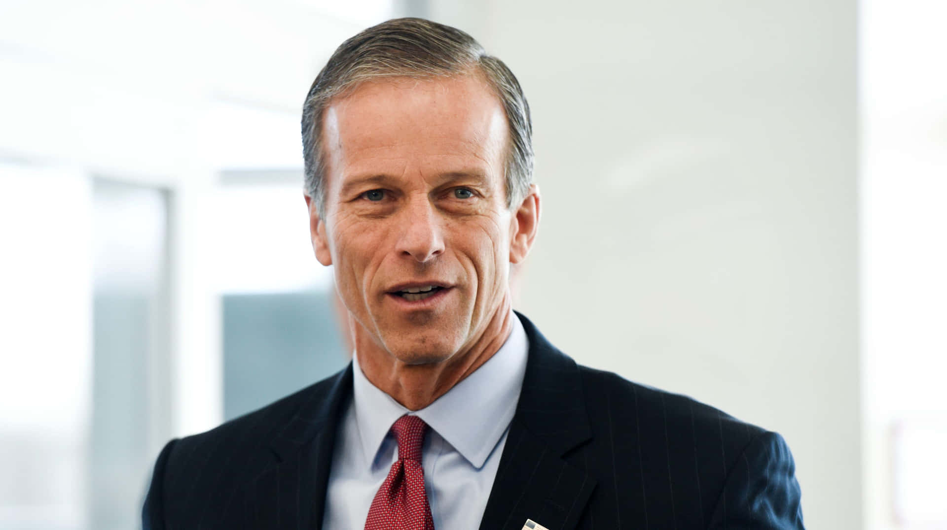 John Thune Red Tie Black Suit Background