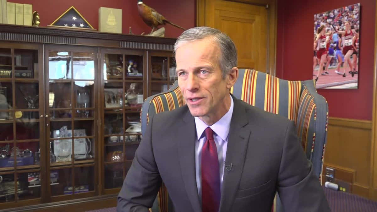 John Thune Sitting On Chair Background