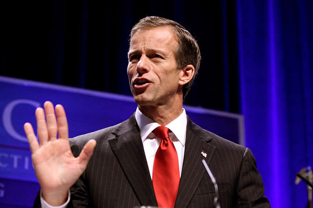 John Thune With Partially Raised Hand Background