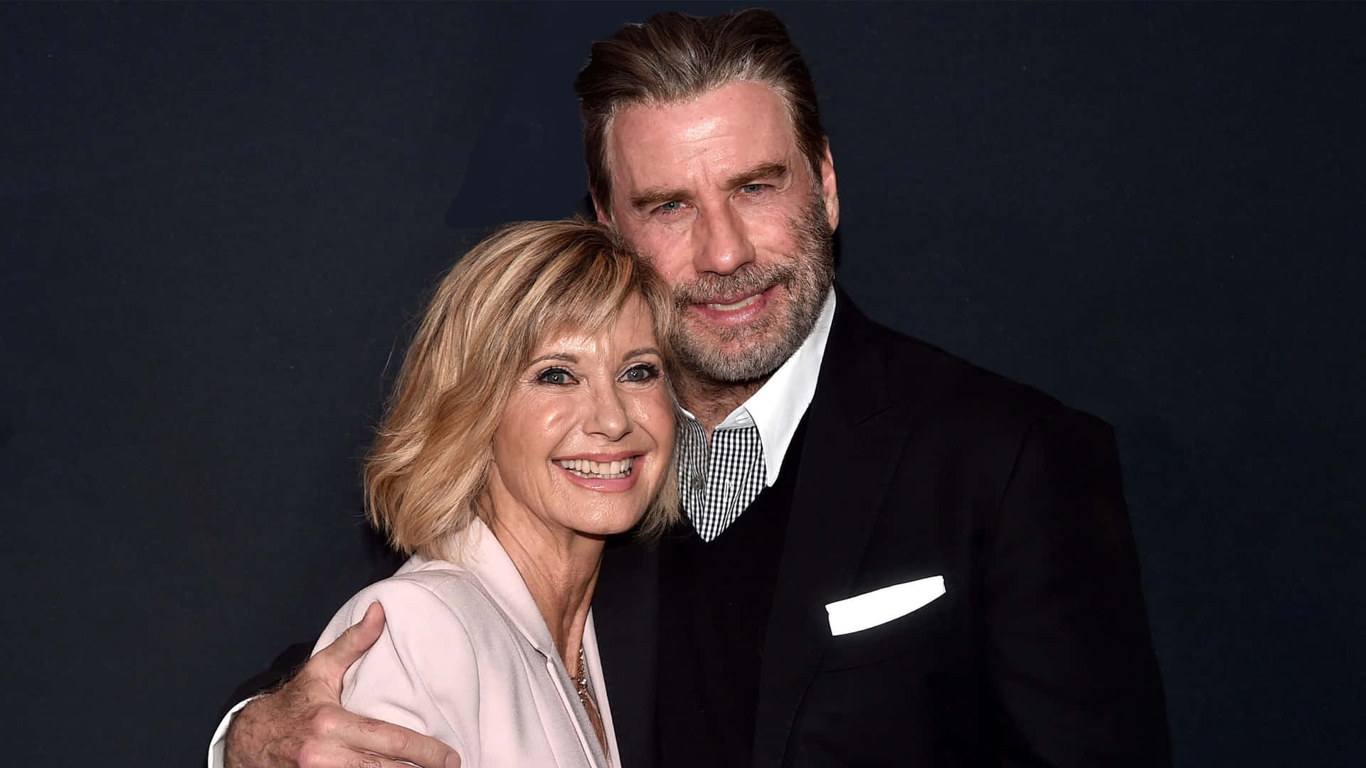 John Travolta Posing With Olivia Newton John Background