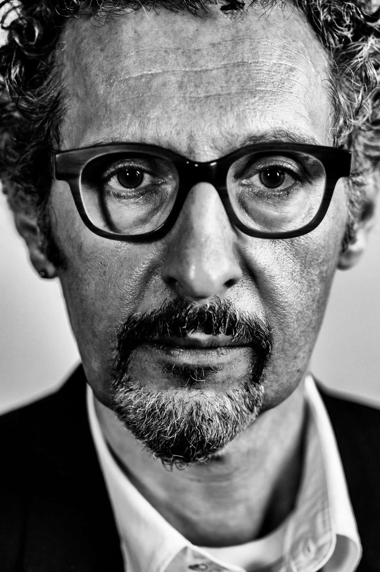 John Turturro Rocking A Stylish Black Hat Background
