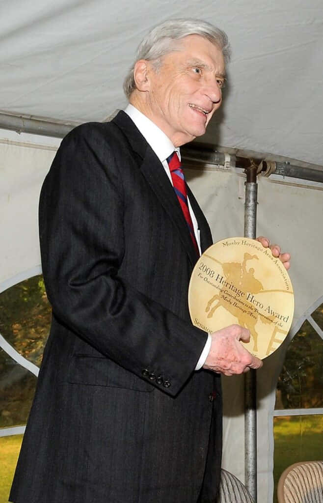 John Warner Holding A Trophy Phone