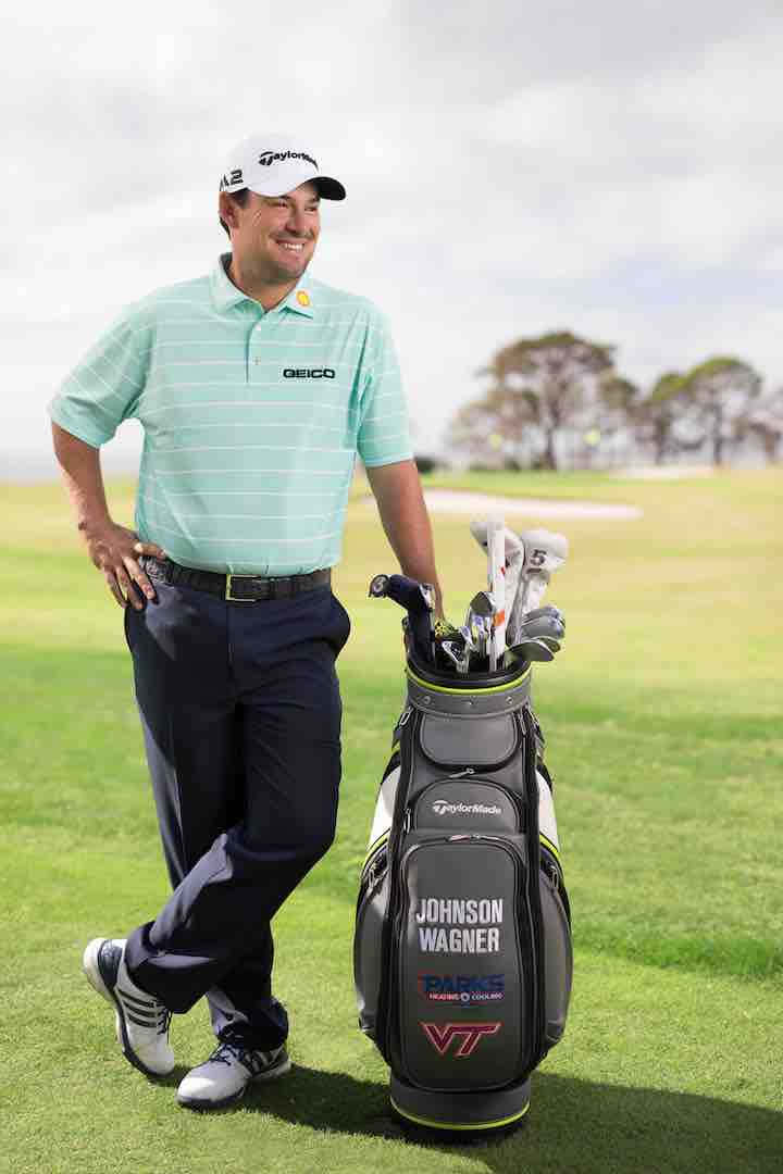 Johnson Wagner Leaning On His Golf Bag Background