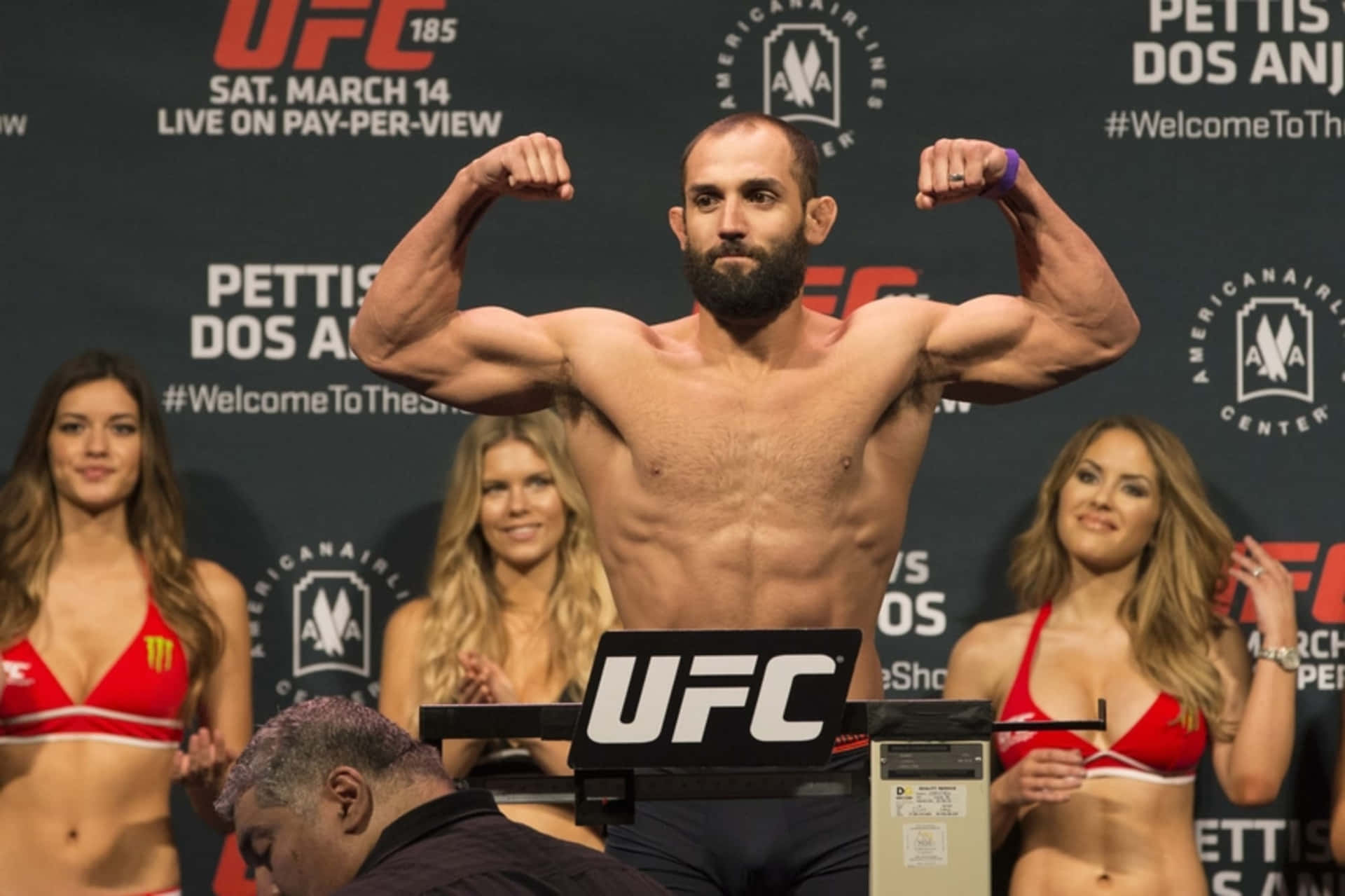 Johny Hendricks In Front Of Ring Girls Background