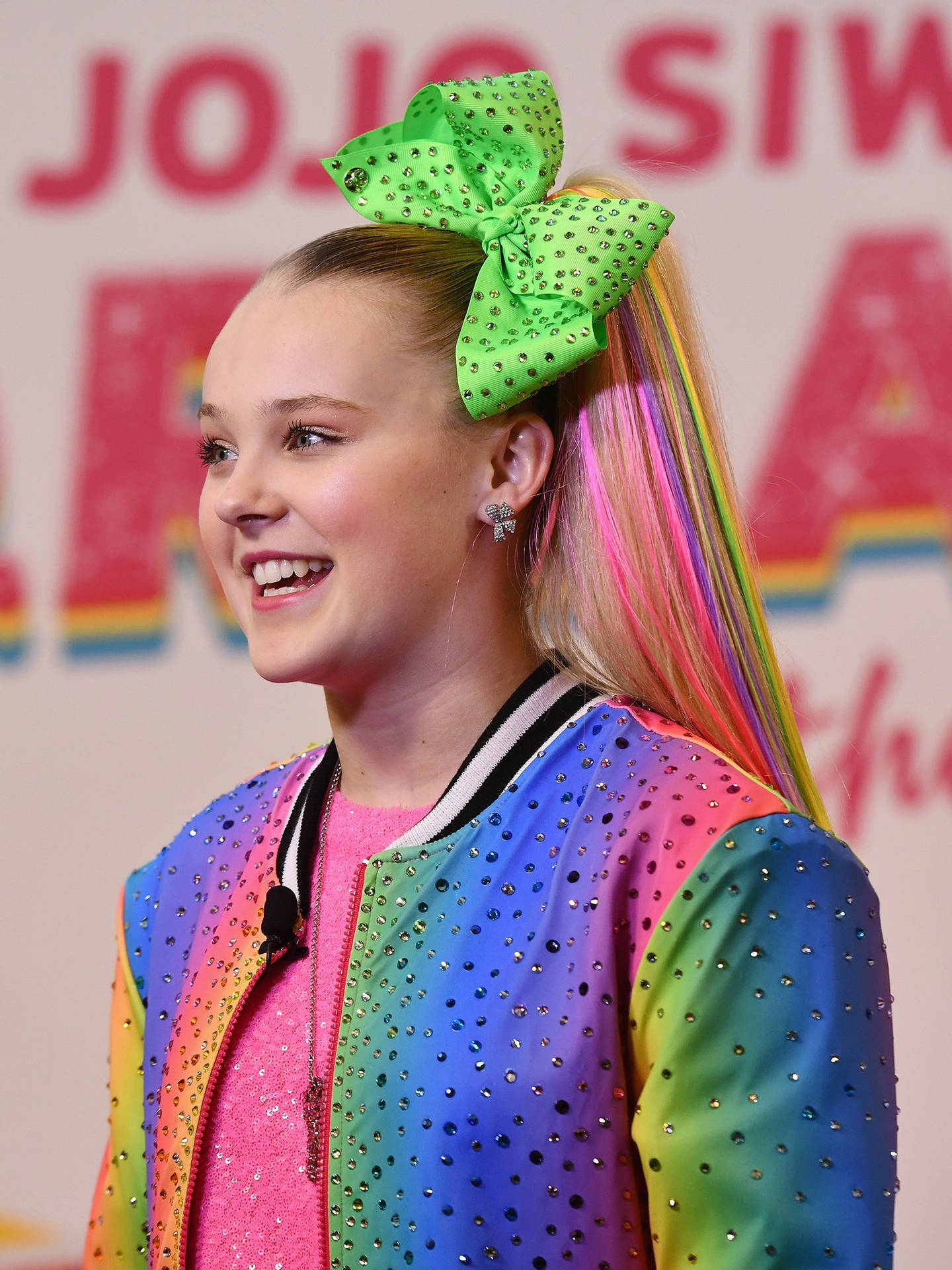 Jojo Siwa Wearing Rainbow Jacket Background