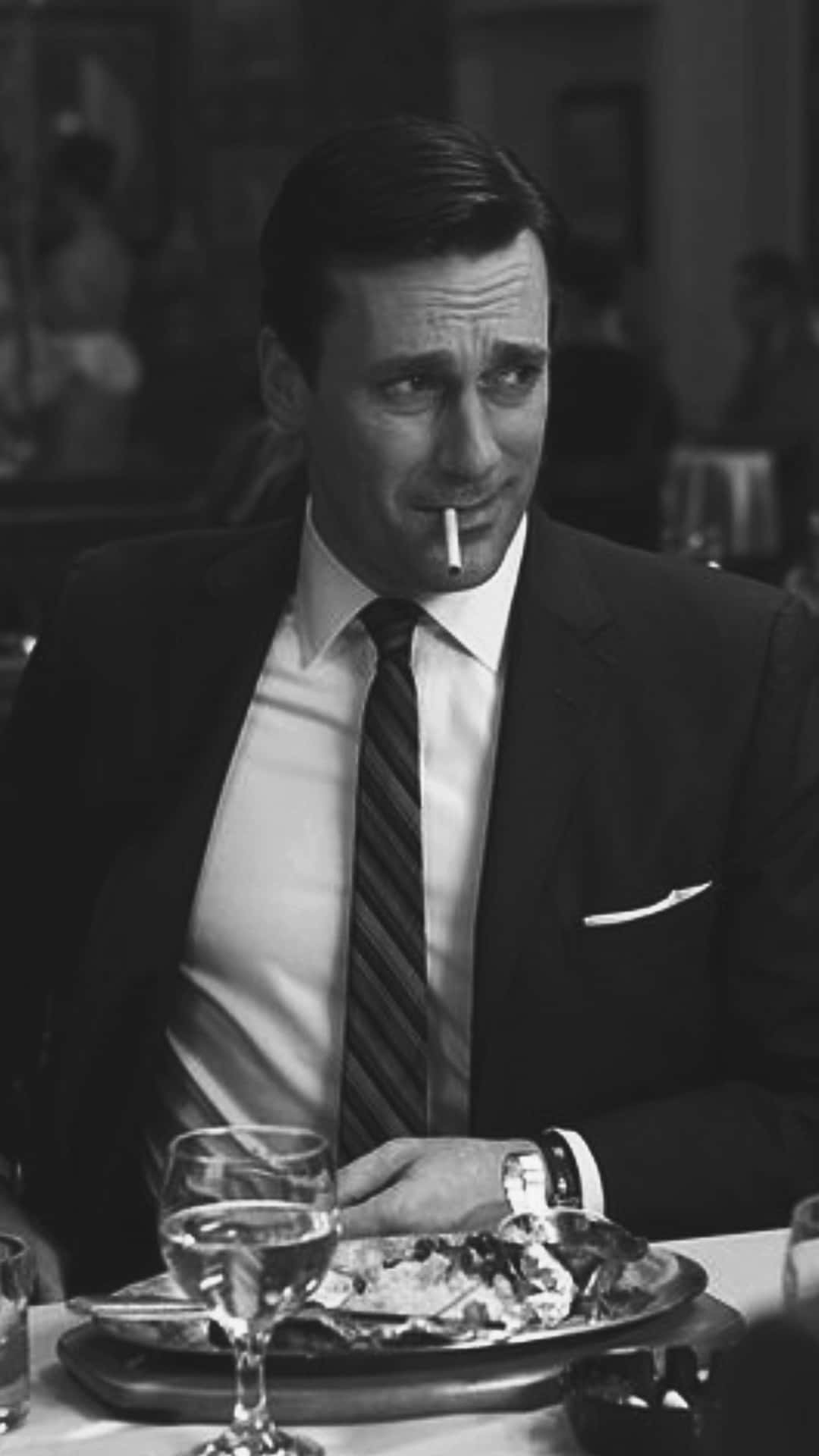 Jon Hamm Exudes Elegance In A Classic Men's Suit Background