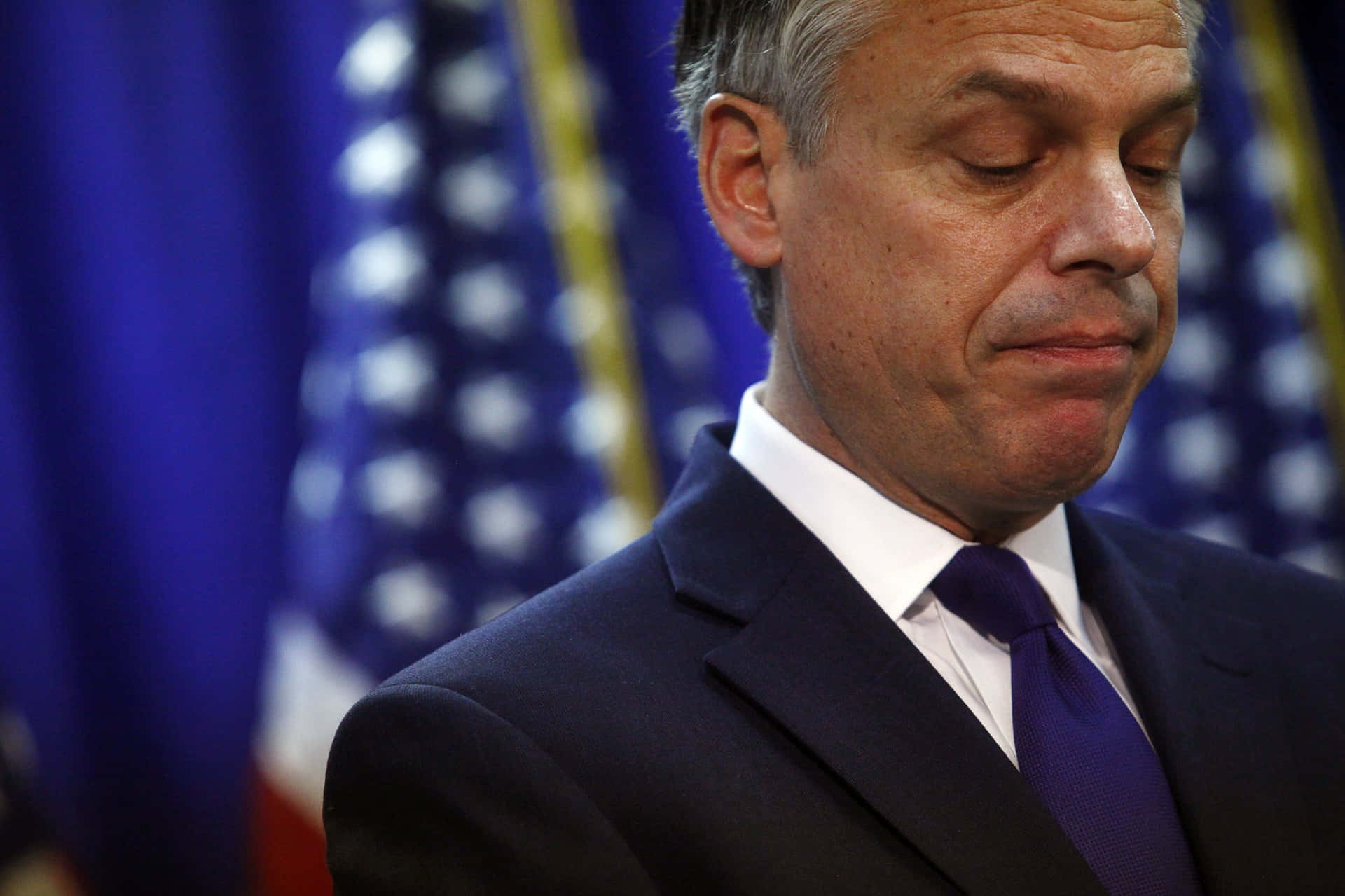 Jon Huntsman Looking Down Background