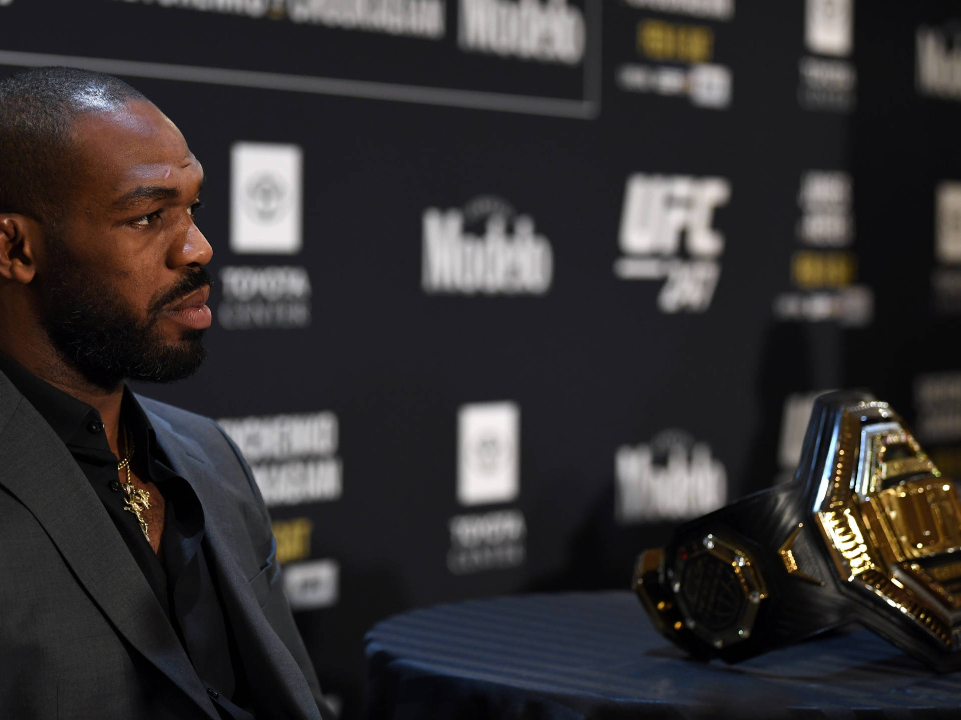 Jon Jones In Suit At Press Con Background