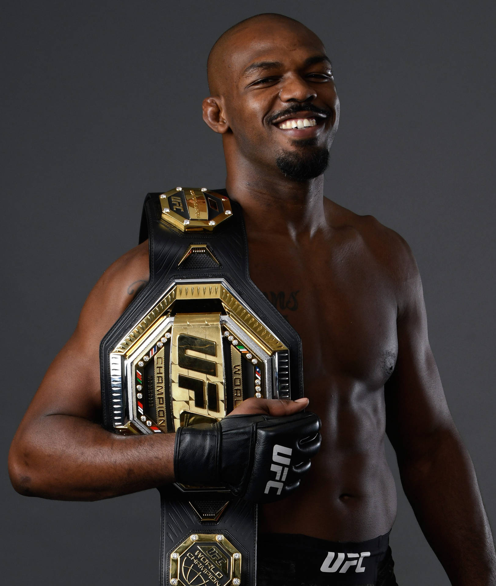 Jon Jones Smiling With Champ Belt Background