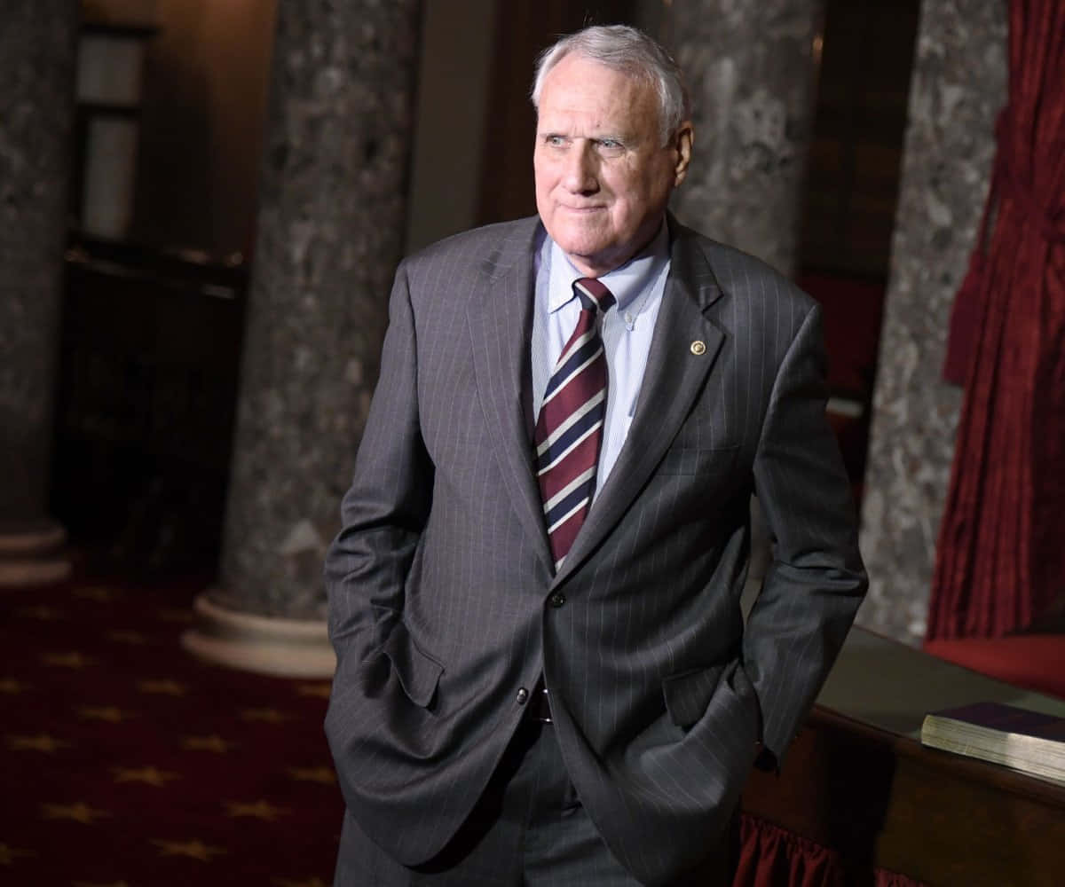 Jon Kyl Wearing Gray Suit Background