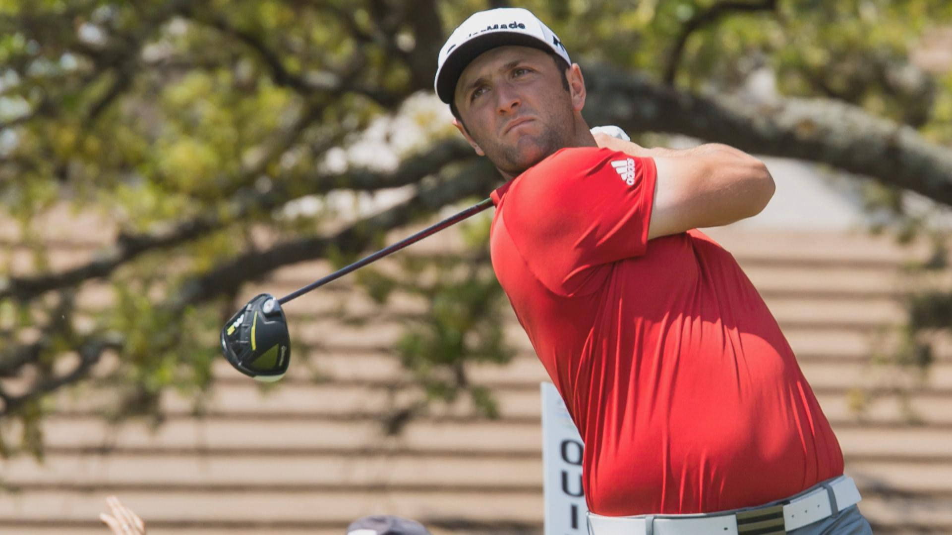 Jon Rahm Hitting Off The Ball Background