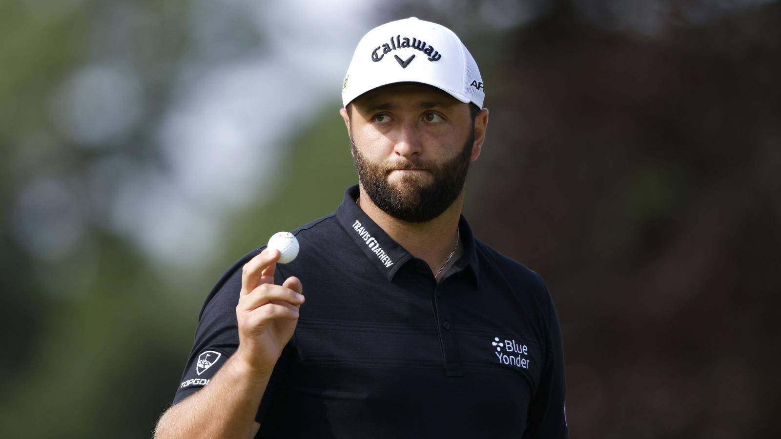 Jon Rahm Holding A Golf Ball Background