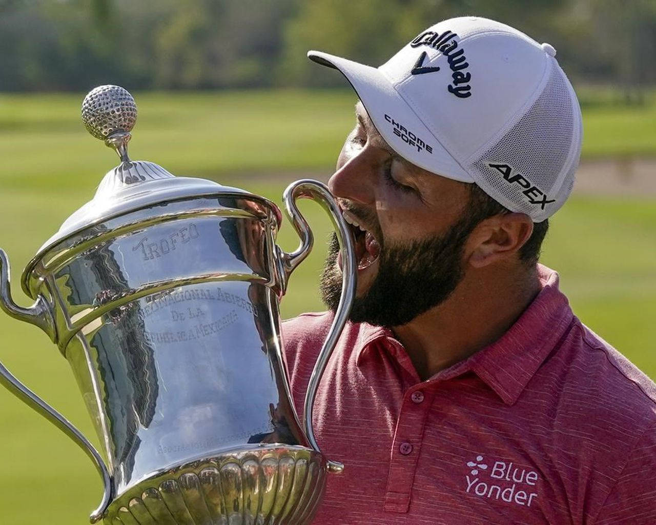 Jon Rahm Joking With His Trophy Background