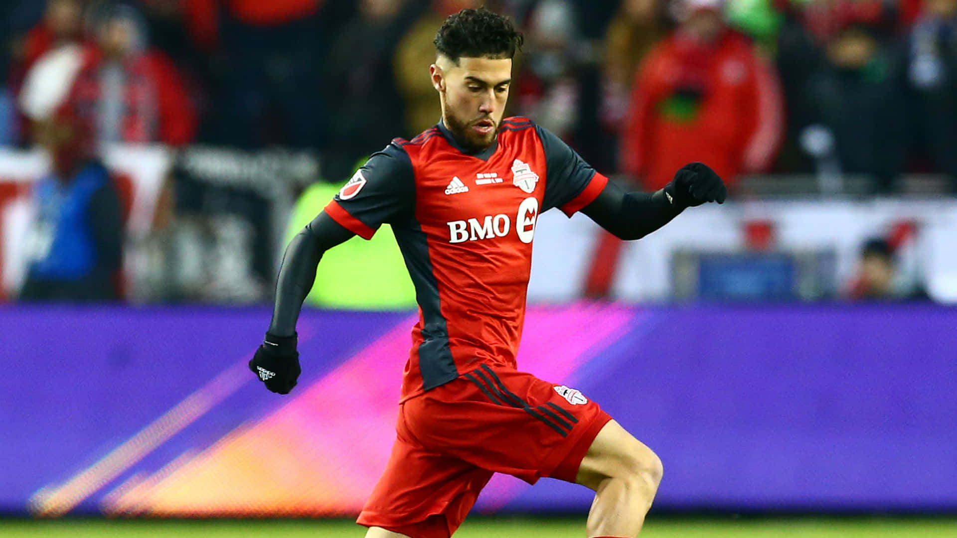 Jonathan Osorio Wearing Toronto Fc Uniform Background