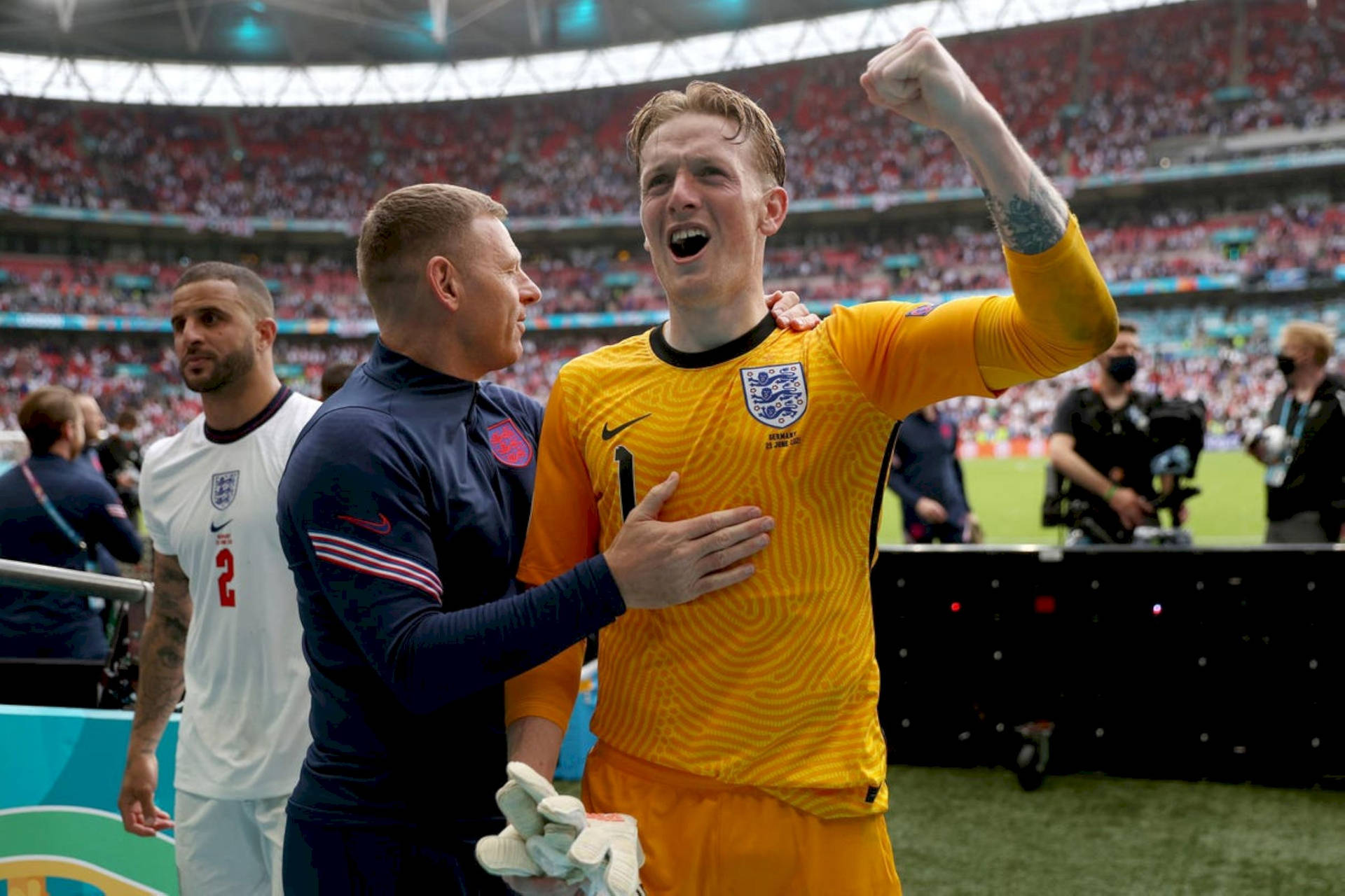 Jordan Pickford Celebrating In Yellow Uniform Background