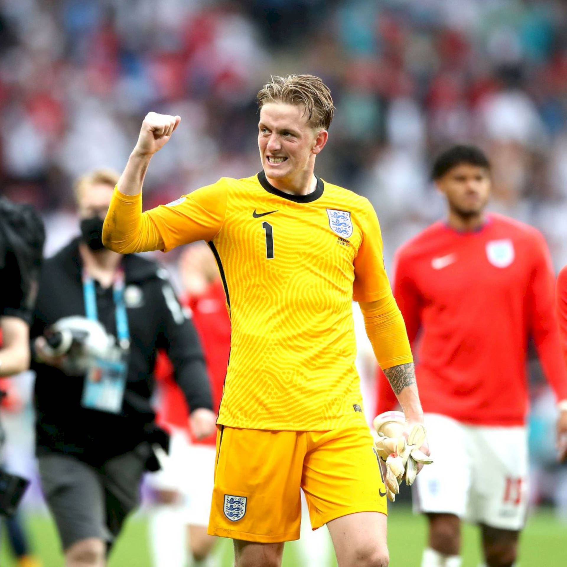 Jordan Pickford In Bright Yellow Uniform Background