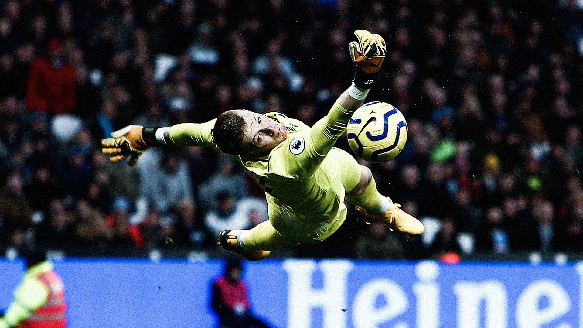 Jordan Pickford Jumping Towards Football Background