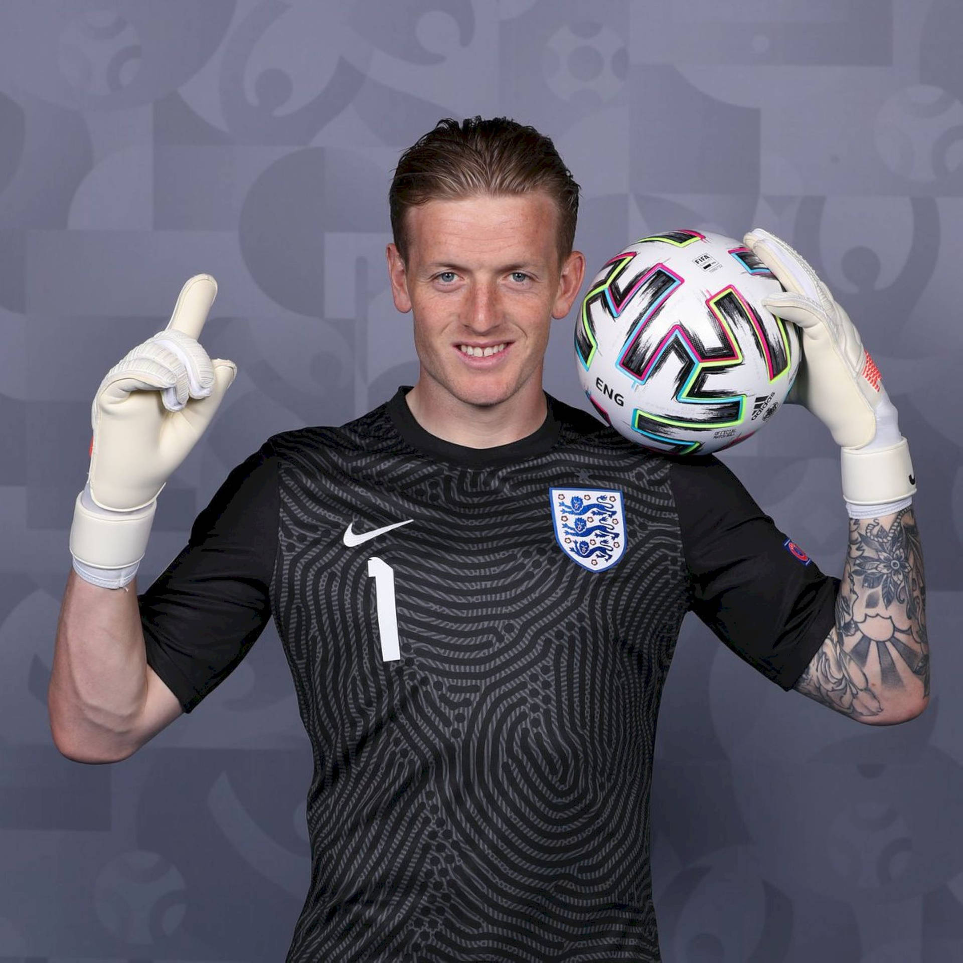 Jordan Pickford Posing With Football Background