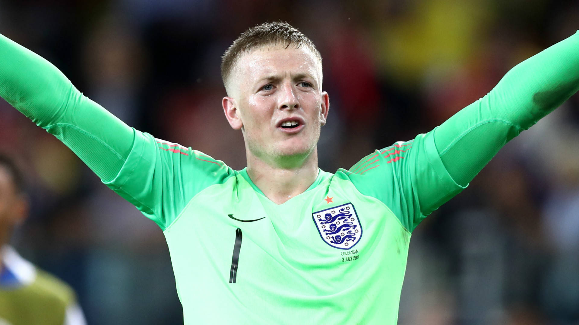 Jordan Pickford Raising Arms In Green Background