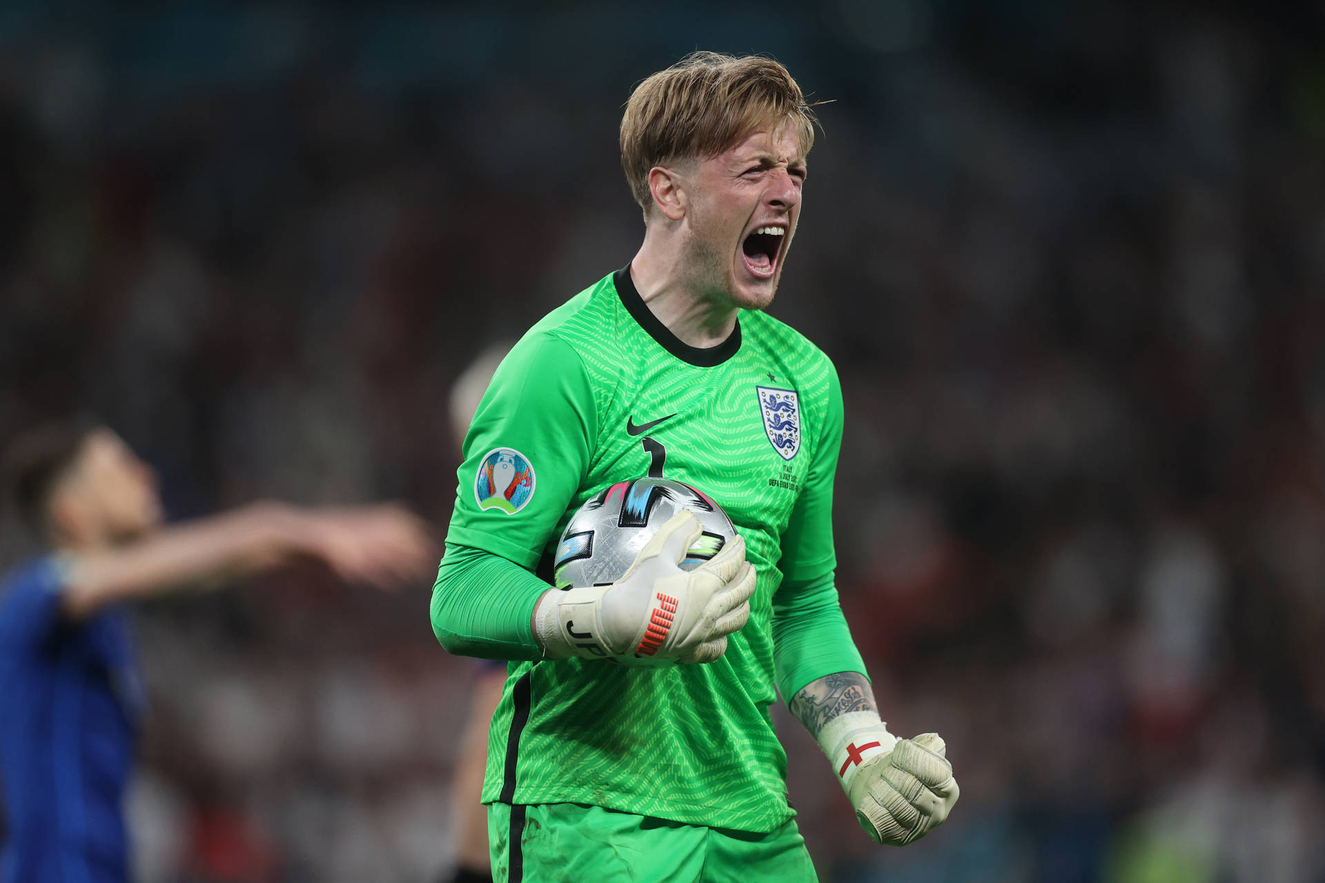 Jordan Pickford Yelling While Carrying Football Background
