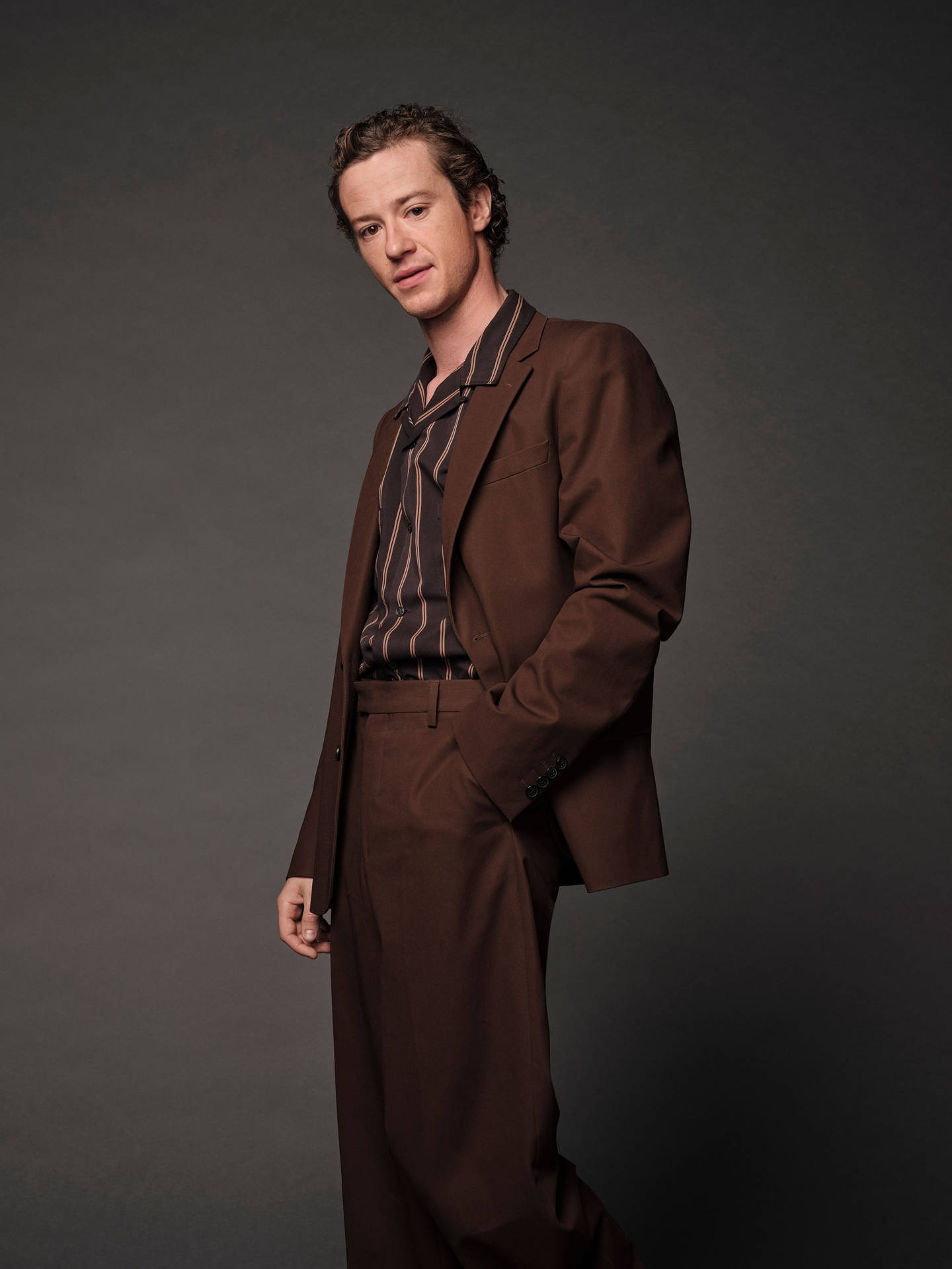 Joseph Quinn In Brown Suit