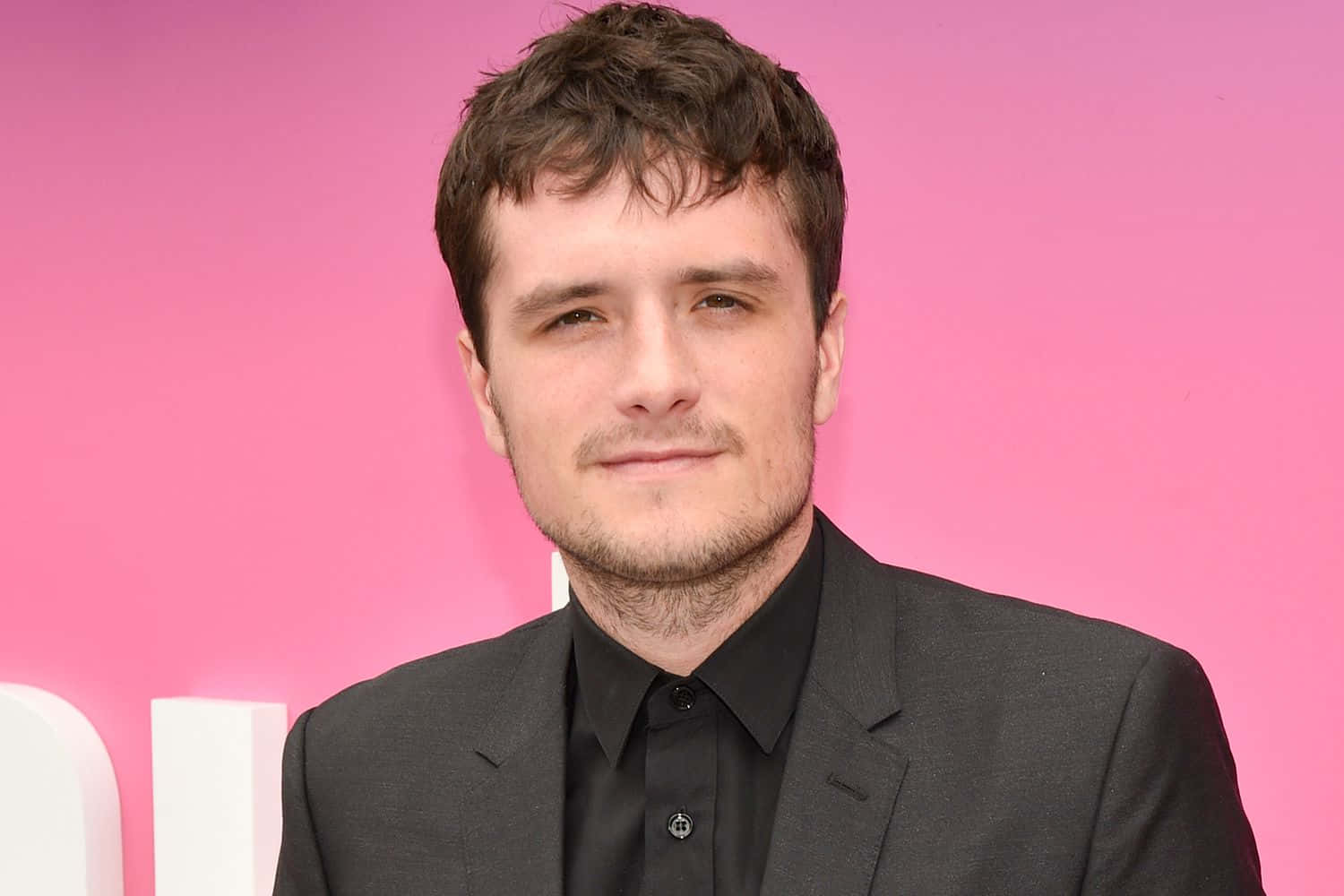 Josh Hutcherson Black Suit Pink Backdrop