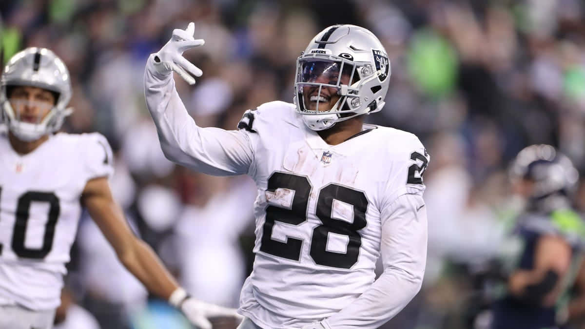 Josh Jacobs Celebrationon Field Background