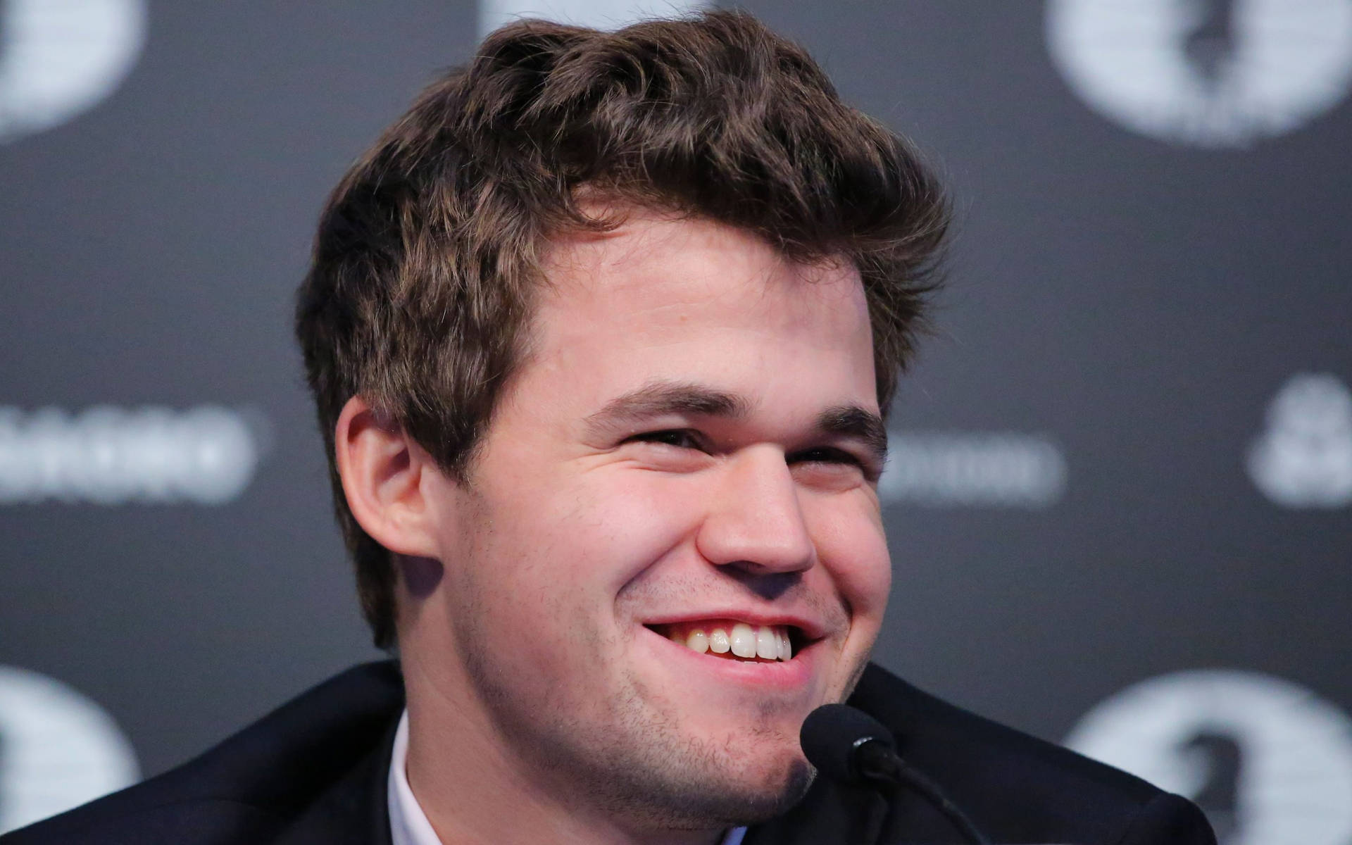 Joyful Magnus Carlsen Celebrating His Winning Move Background