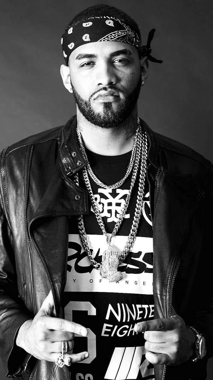 Joyner Lucas Gracing The Stage In His Signature Outfit. Background