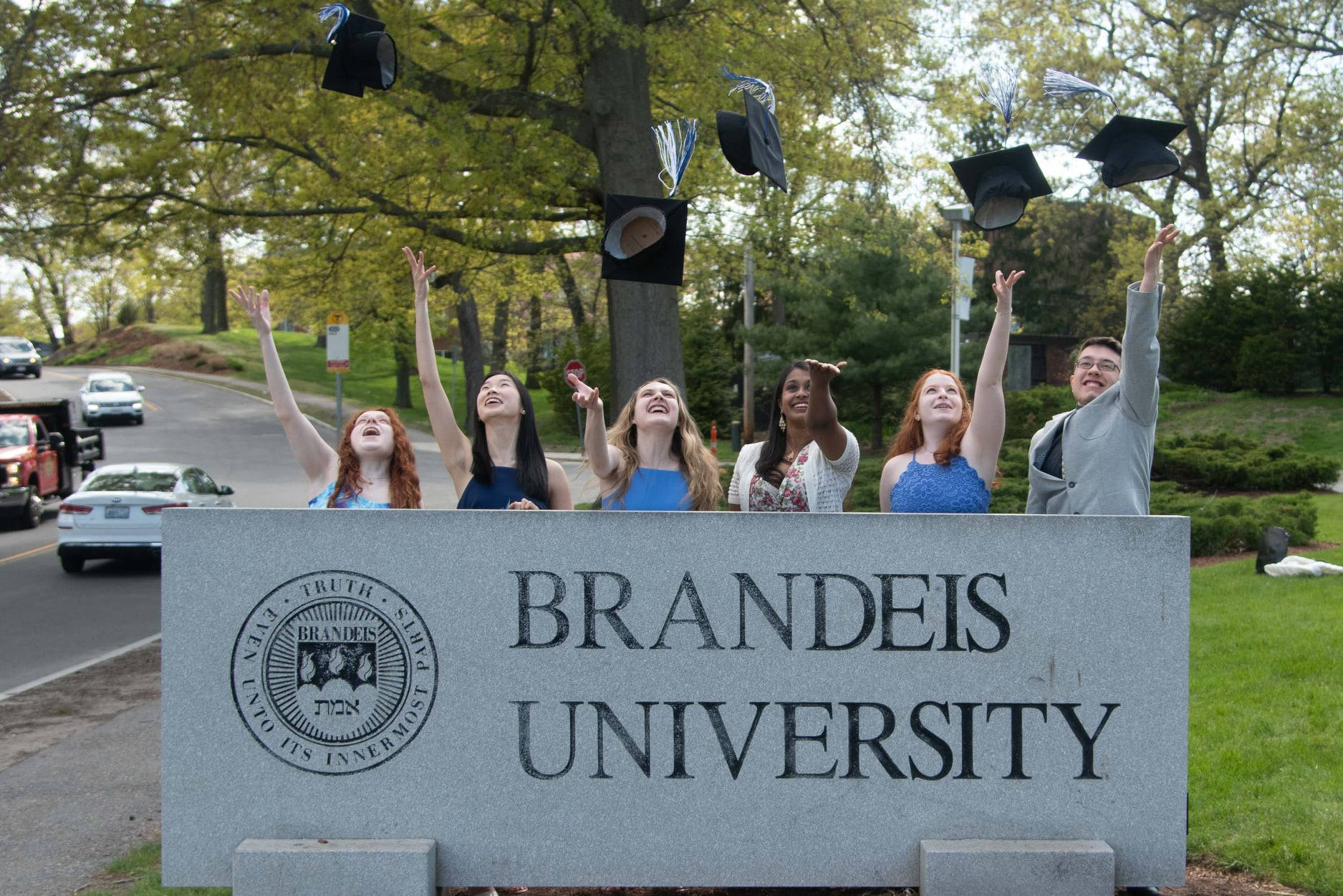 Joyous Brandeis University Graduates Celebrating By Throwing Their Caps