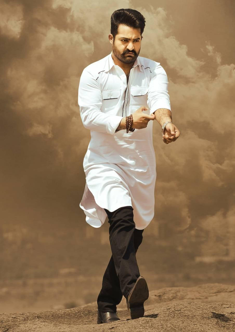 Jr Ntr In A Dapper Look Rolling Up His Sleeves Background