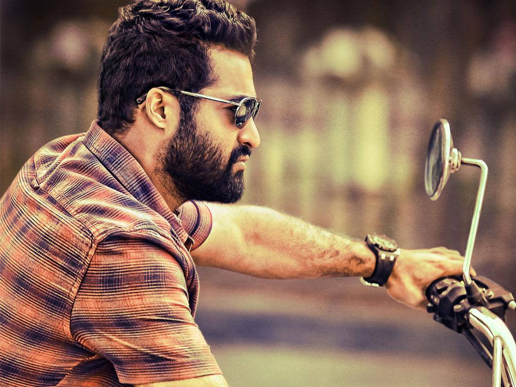 Jr Ntr On A Motorcycle Background