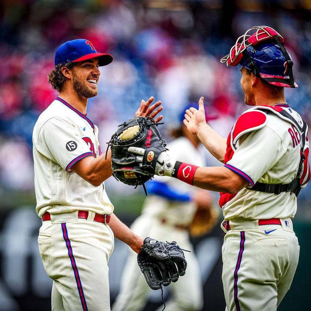 Jt Realmuto High Five With Teammate Background