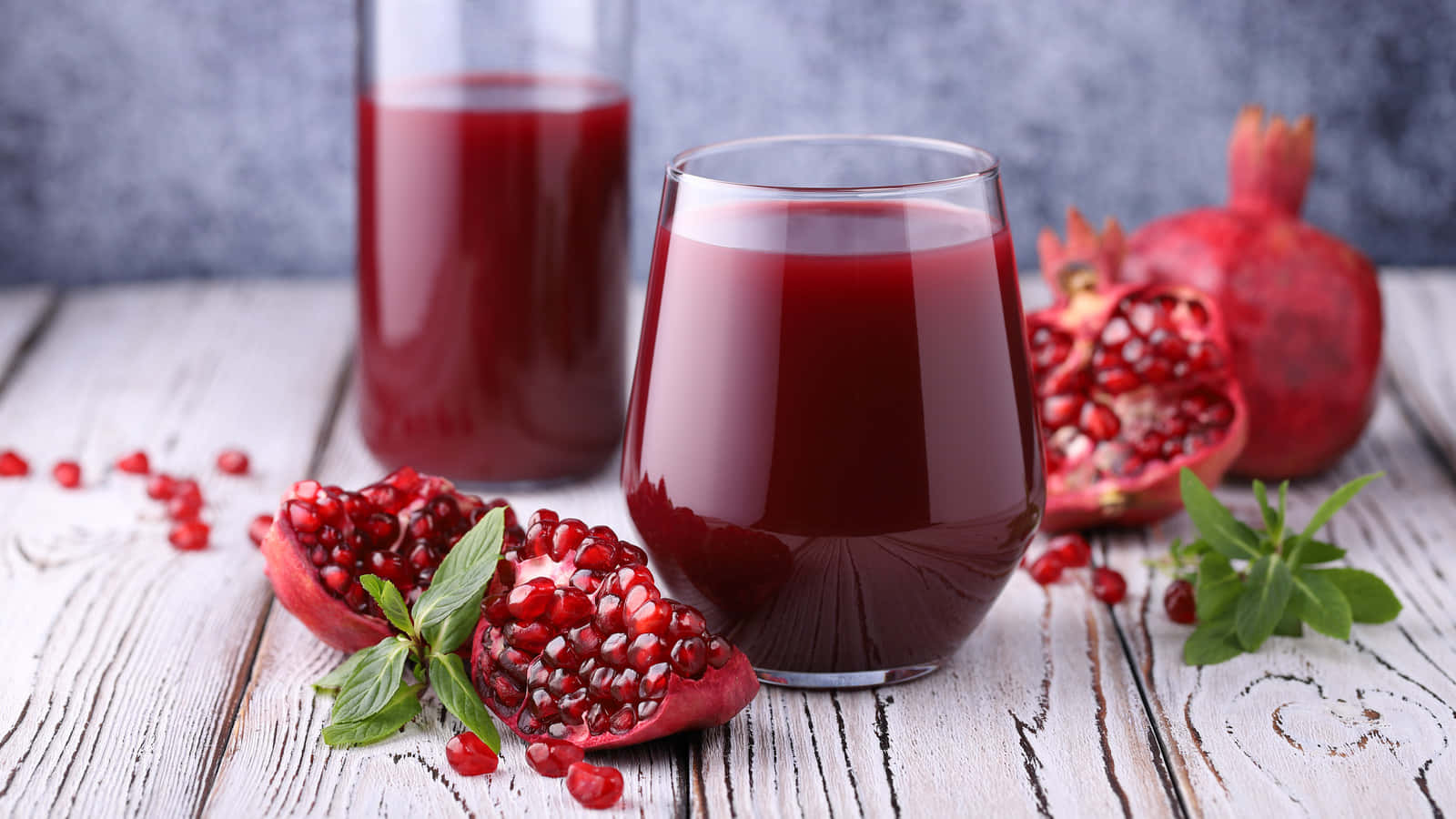 Juice With Fresh Pomegranate Fruits Background