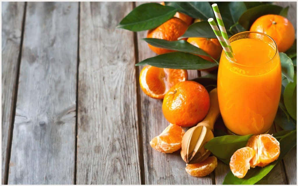 Juice With Orange Fruits And Leaves Background