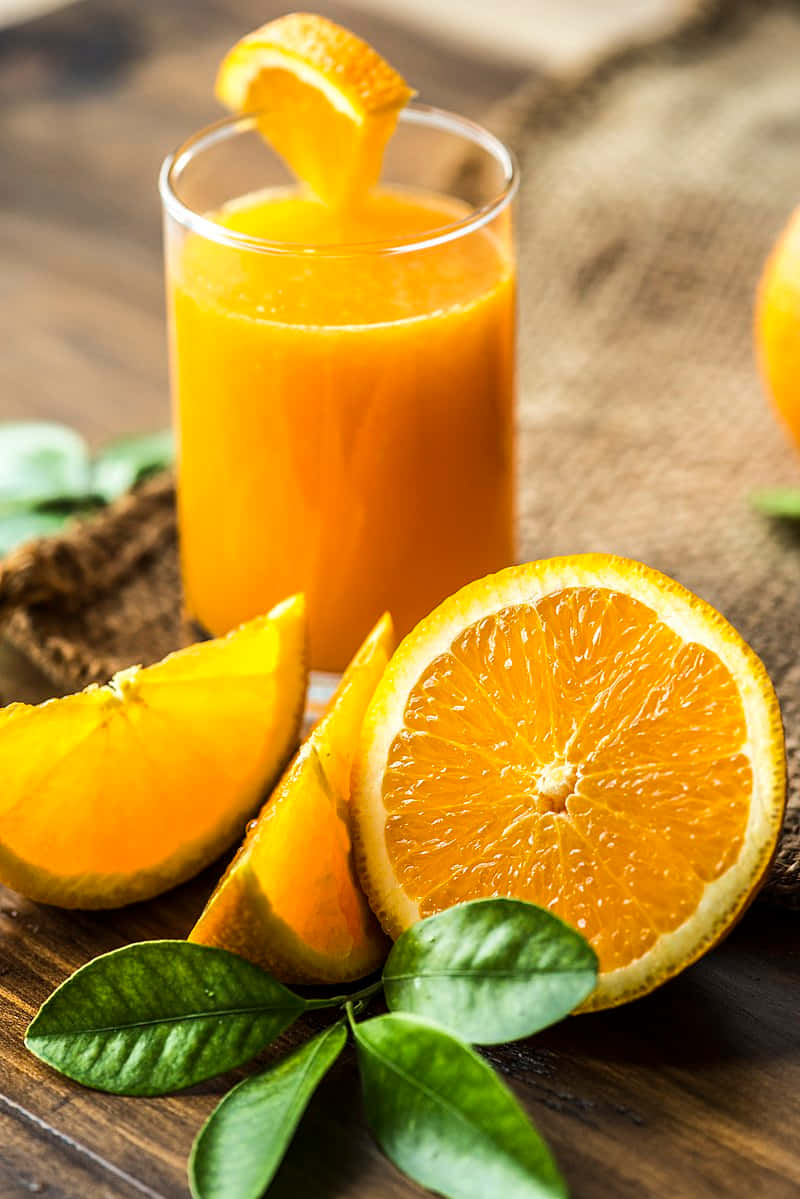 Juice With Orange Wedge And Wheel Slices Background