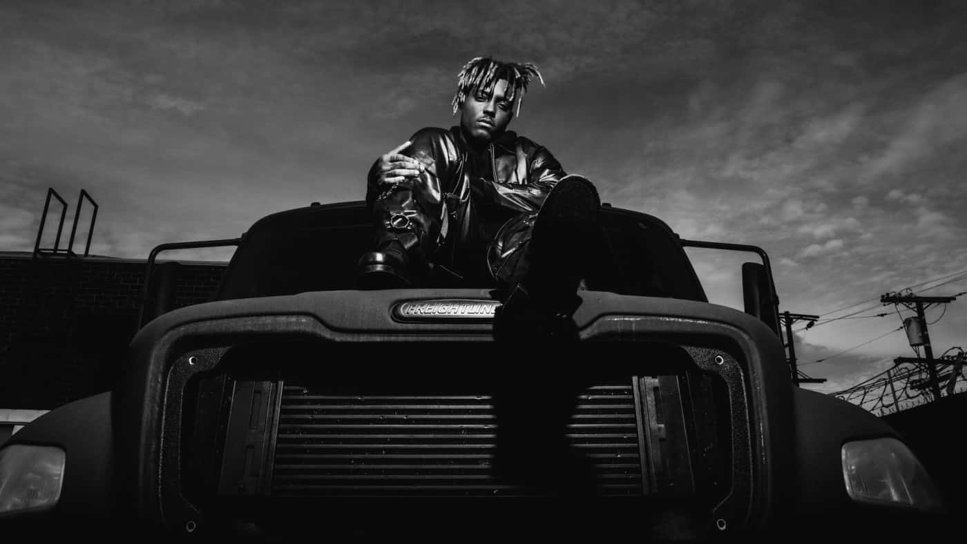 Juice Wrld Sitting On A Car Posthumous Background
