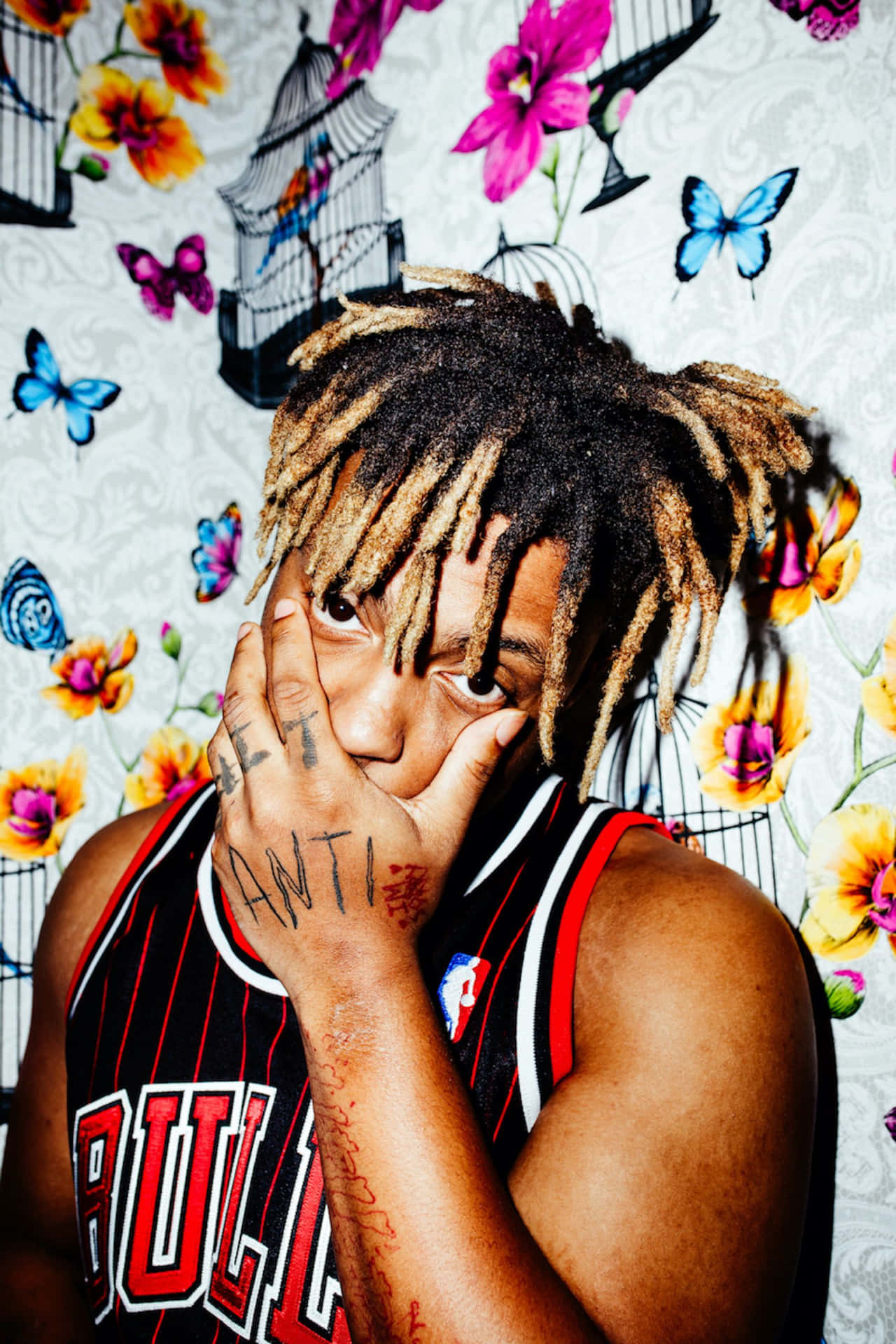 Juice Wrld Surrounded By His Artwork Background