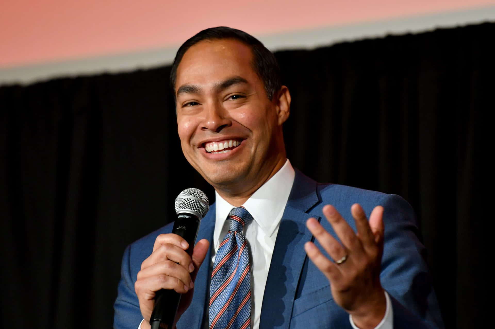 Julian Castro Donning A Striped Blue Tie Background