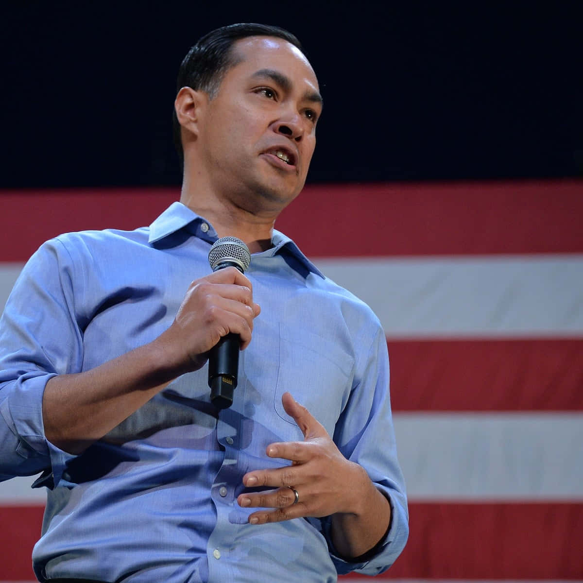 Julian Castro Holding A Microphone Background