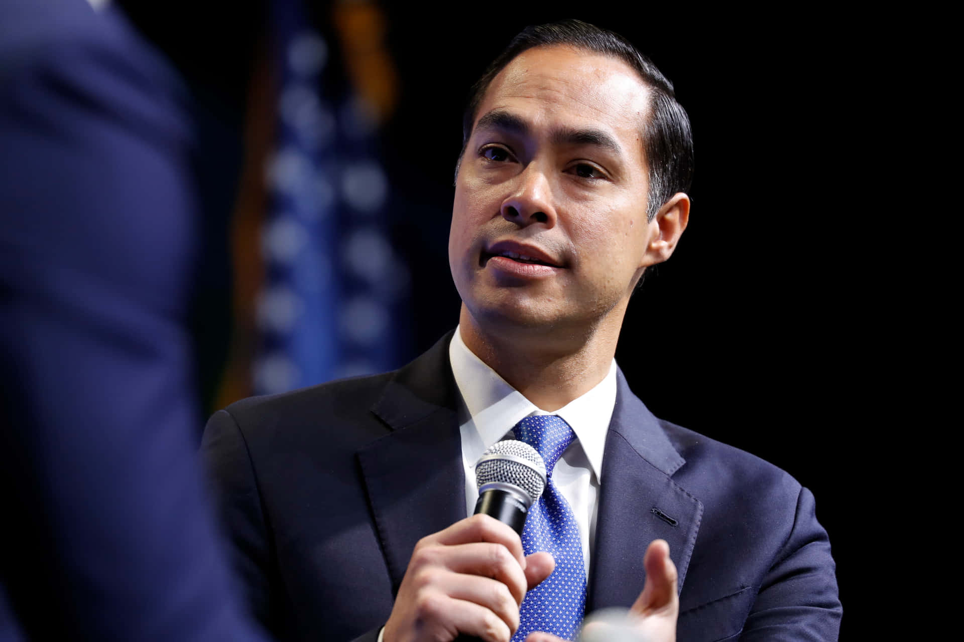 Julian Castro Holding Microphone Close-up Background