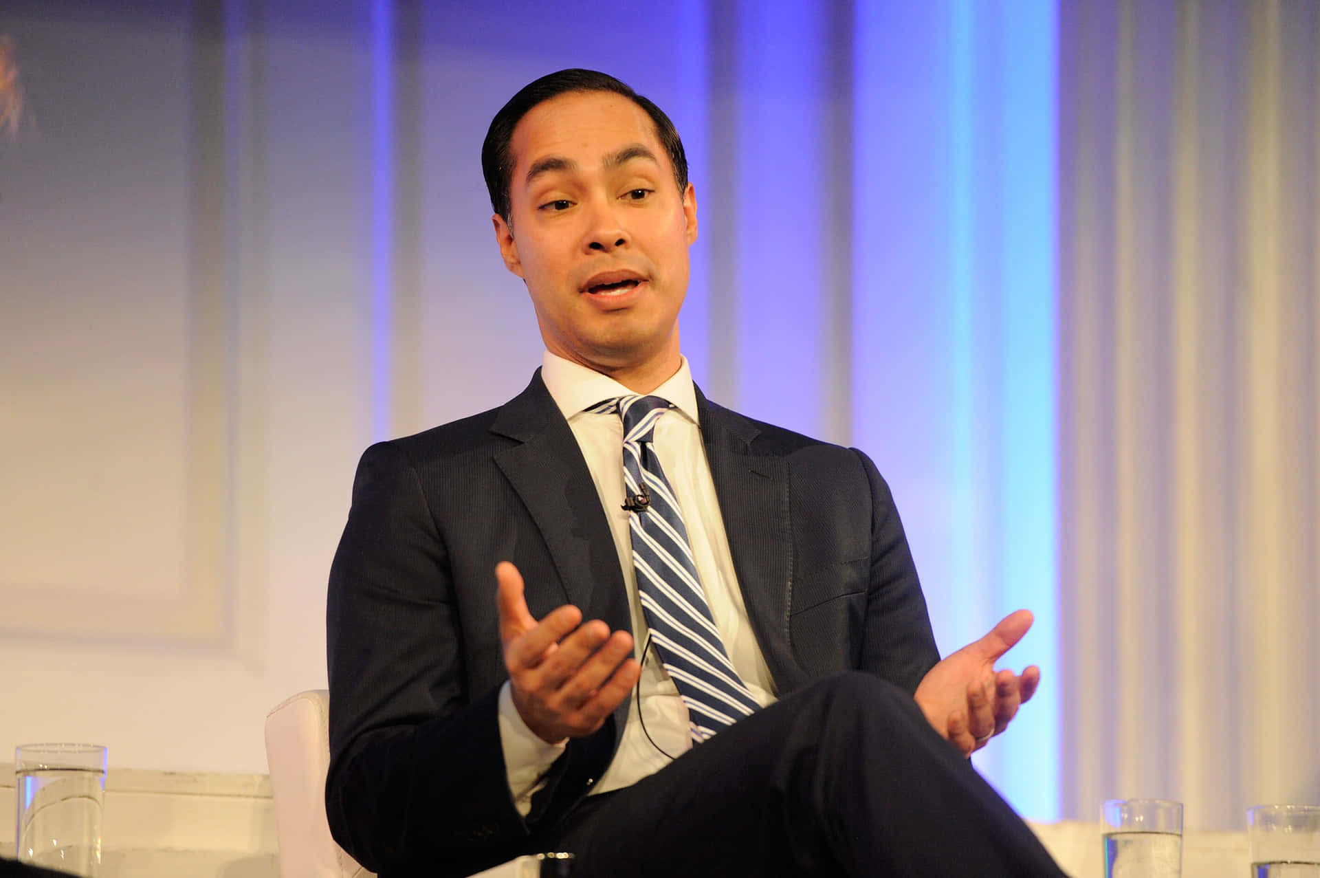 Julian Castro Sitting And Shrugging Background