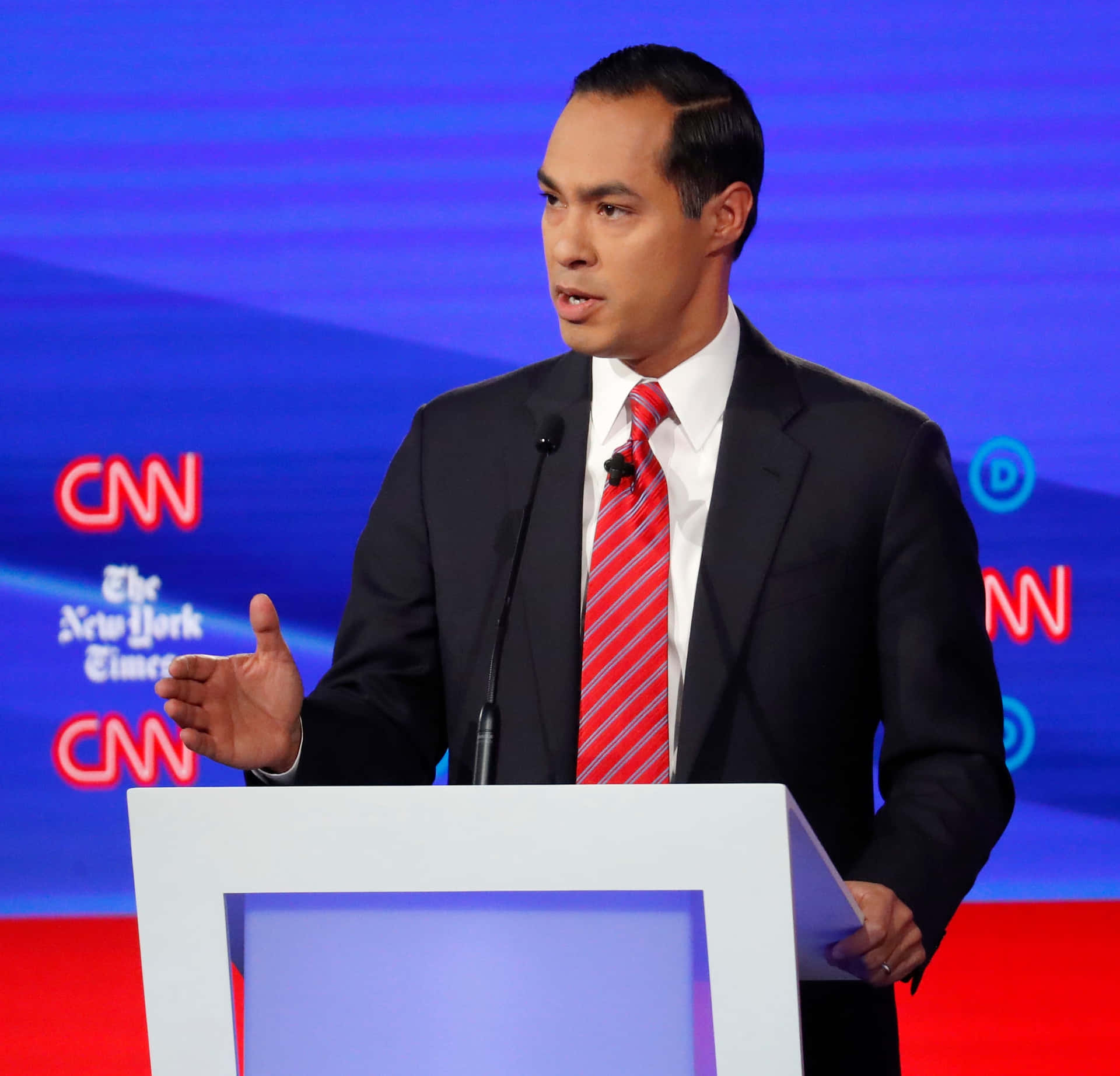 Julian Castro Speaking At A Podium Background