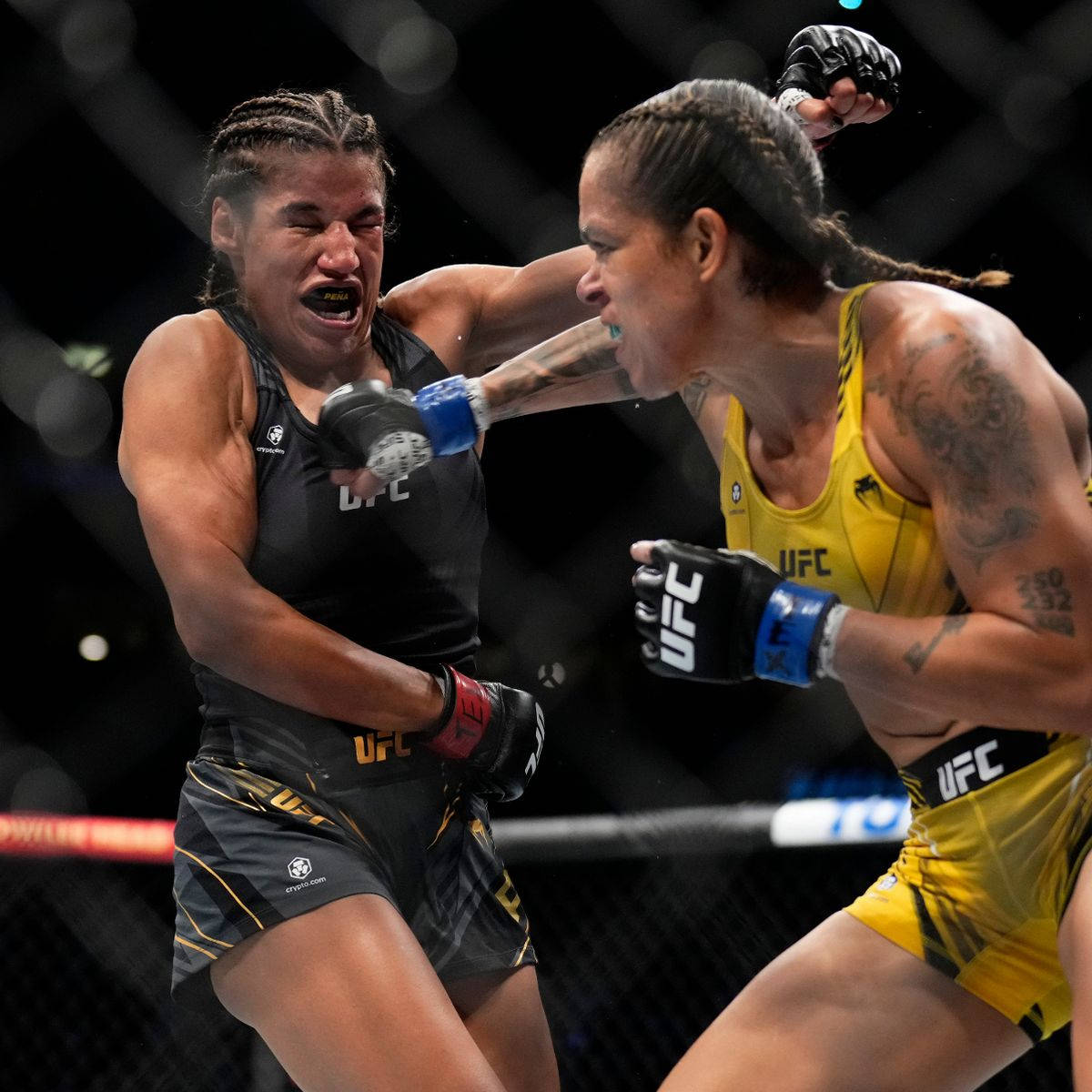 Julianna Peña Dodging Punch Of Amanda Nunes Background