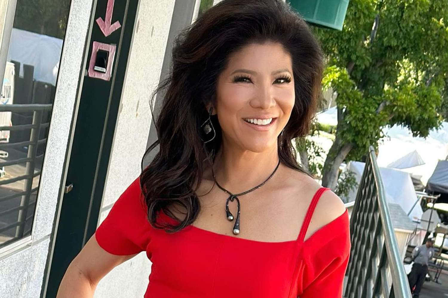 Julie Chen Red Top Smile Outdoors Background