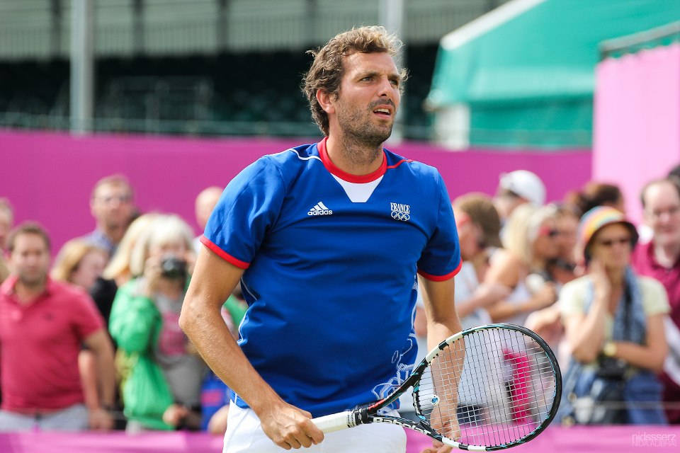 Julien Benneteau In Blurry Pink Background Background