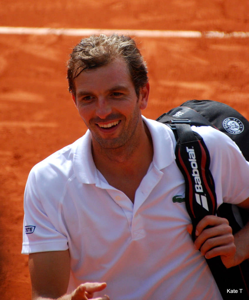 Julien Benneteau Radiating Joy On Court Background